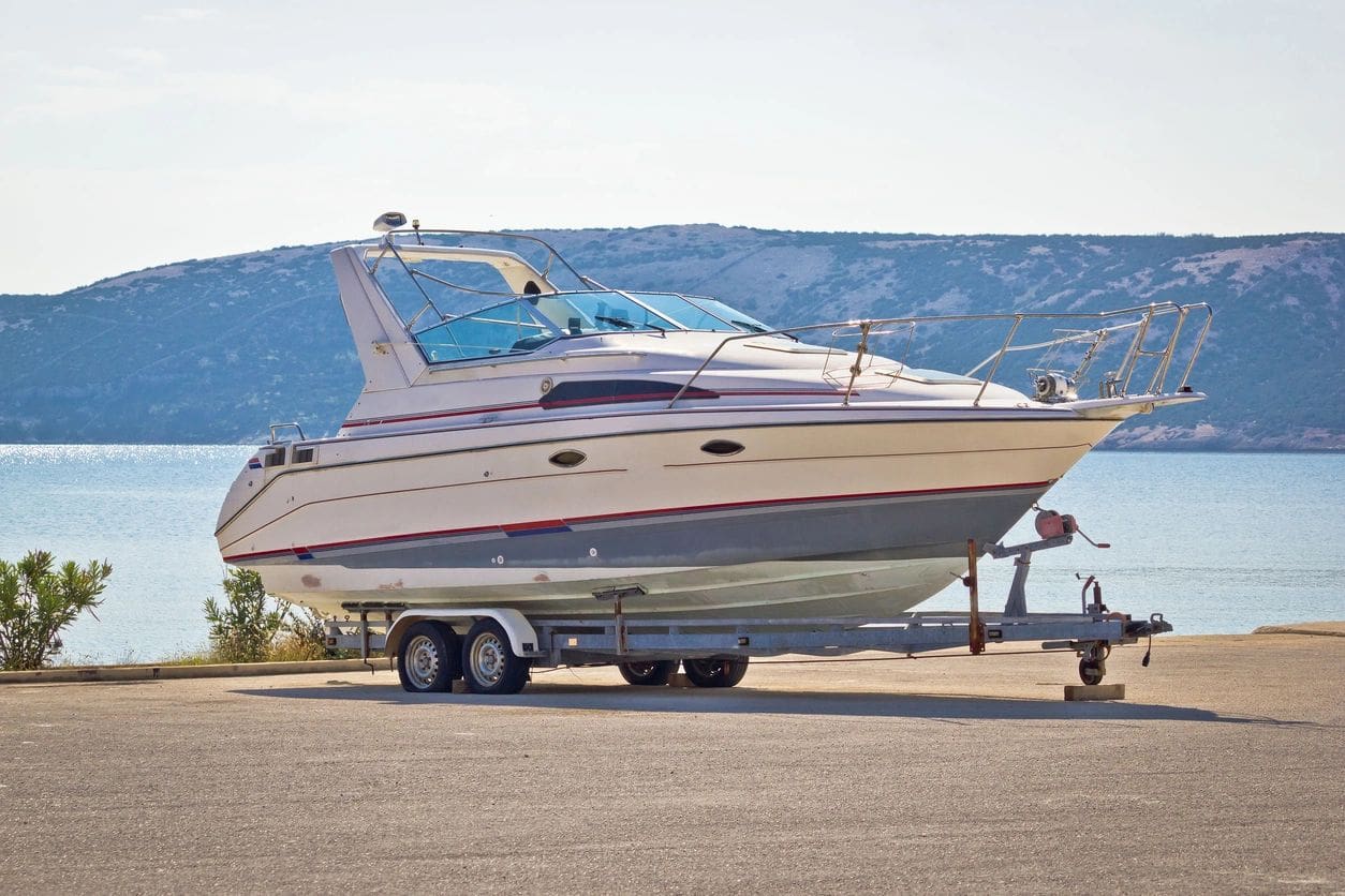 A boat is parked on the side of the road.