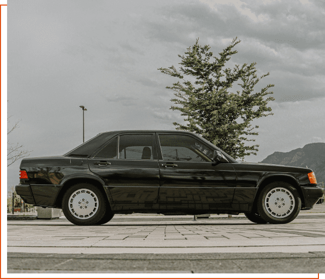 A black car parked on the side of a road.